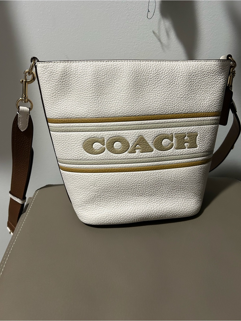 COACH White Pebbled Leather Bucket Bag with Tan Logo and Brown Strap